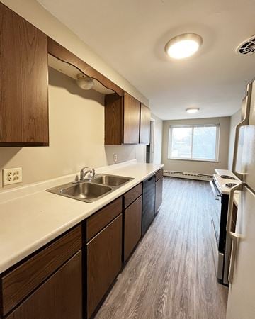 Mankato apartment for rent - A kitchen with a white sink and a white refrigerator.
