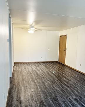 Cokato apartment for rent - an empty living room with wood flooring and white walls