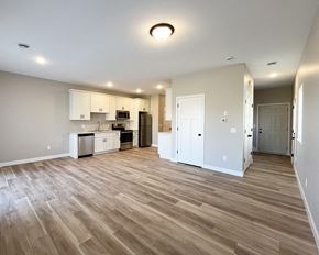 Mankato townhouse for rent - an empty living room and kitchen with wood flooring