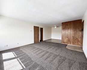 Mankato apartment for rent - an empty living room with carpet and white walls