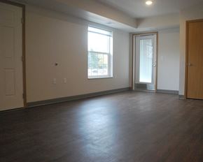 Le Sueur townhouse for rent - an empty living room with wood floors and a window