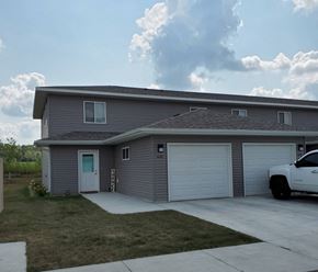 Northfield townhouse for rent - A grey house with a white truck parked in front.