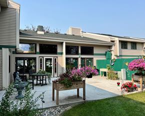 Crookston apartment for rent - A house with a green wall and a wooden bench in front of it.