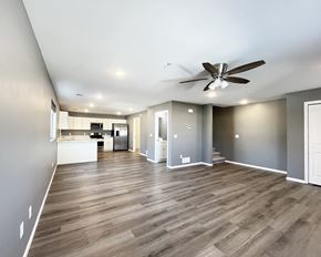 Mankato townhouse for rent - A spacious room with a ceiling fan and wooden flooring.