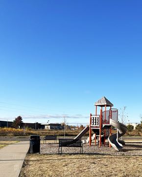 Forest Lake apartment for rent - a playground with a slide and a bench in a park