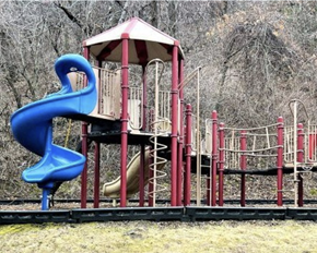 Red Wing apartment for rent - A playground with a blue slide and a red and white structure.