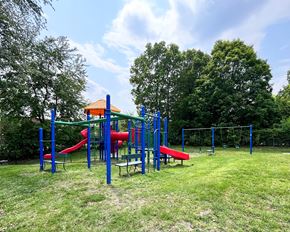 Northfield apartment for rent - A playground with a red slide and blue poles.