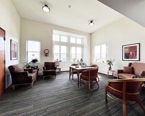 Rochester apartment for rent - A living room with a couch, chairs, and a table.