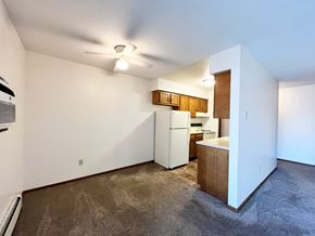 North Mankato apartment for rent - A room with a white wall and a ceiling fan.
