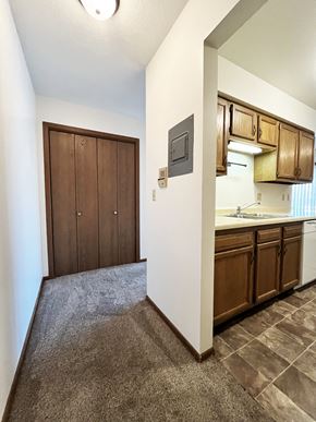 North Mankato apartment for rent - A kitchen with brown cabinets and a white wall.