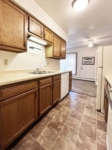 North Mankato apartment for rent - A kitchen with wooden cabinets and a white fridge.