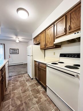 North Mankato apartment for rent - A kitchen with a white stove top oven and white refrigerator.
