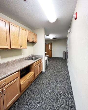 Mankato apartment for rent - A kitchen with wooden cabinets and a grey counter top.