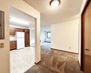 Lonsdale apartment for rent - A kitchen with white appliances and brown cabinets.