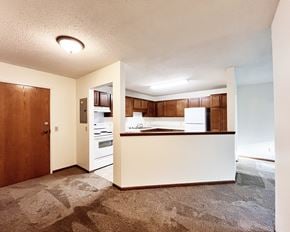 Lonsdale apartment for rent - A kitchen with white appliances and wooden cabinets.
