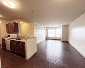Ramsey apartment for rent - A kitchen with brown cabinets and white appliances.