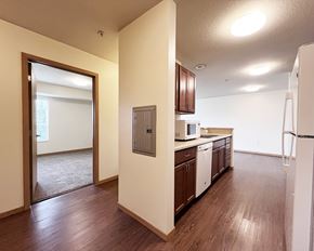 Ramsey apartment for rent - A kitchen with wooden floors and white appliances.