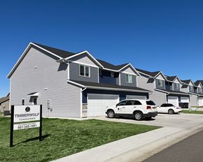 Mankato townhouse for rent - a gray house with a white car parked in front of it
