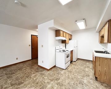 Worthington apartment for rent - A kitchen with a white stove and wooden cabinets.