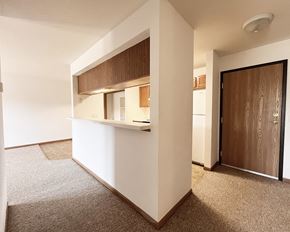 Pine Island apartment for rent - A white kitchen with a brown counter top and a brown door.
