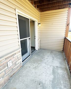 Pine Island apartment for rent - A patio with a sliding glass door and a concrete floor.