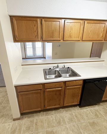 Pine Island apartment for rent - A kitchen with a sink and wooden cabinets.