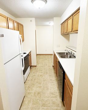 Pine Island apartment for rent - A kitchen with a white refrigerator and a white sink.