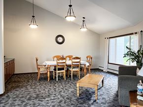 Windom apartment for rent - A dining room with a table set for six and a clock on the wall.