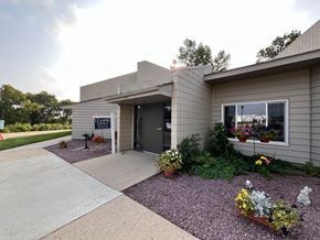 Windom apartment for rent - A house with a grey exterior and a gravel driveway.