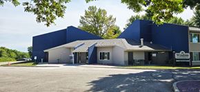 Windom apartment for rent - A large blue building with a sign that says "Windemere" in front of it.