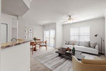 Lenexa apartment for rent - a living room with a couch and a table