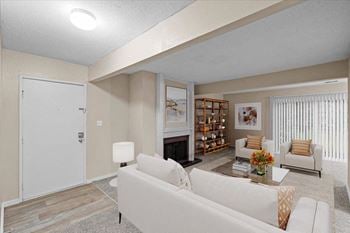 A living room with white furniture and a fireplace