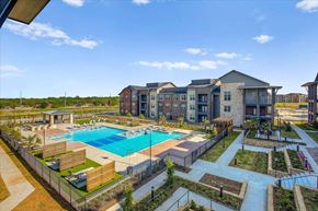 Denton apartment for rent - an aerial view of an apartment complex with a swimming pool