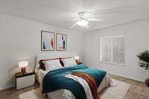 Olathe apartment for rent - a bedroom with a bed and a ceiling fanat Millcreek Woods Apartments, Olathe, 66061