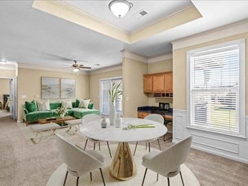 Olathe apartment for rent - a living room with a white table and chairs