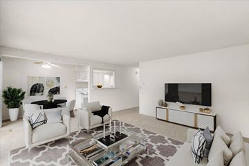 Overland Park apartment for rent - a living room with white furniture and a television