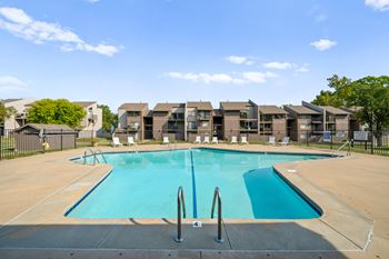 Swimming pool surrounded by the lounge chairs