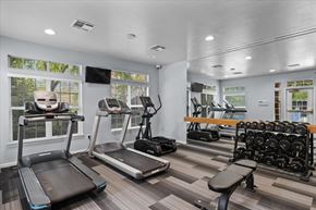 Overland Park apartment for rent - A gym with treadmills, elliptical machines, and dumbbells.at Crowne Chase Apartment Homes, Overland Park, KS, 66210