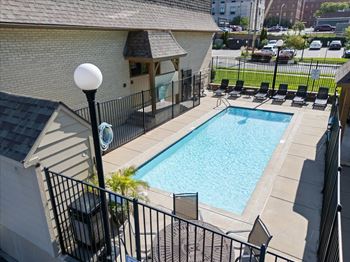 A black iron fence surrounds a small pool.