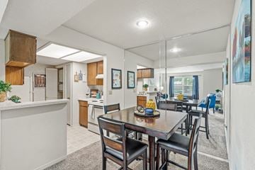 Overland Park apartment for rent - a living room with a dining room table and chairs and a kitchen with a counter