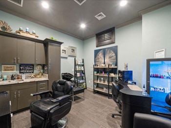 A salon room with two chairs and a computer