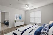 Olathe apartment for rent - a bedroom with a large bed and a ceiling fan at Stonepost Lakeside, Olathe, KS, 66062