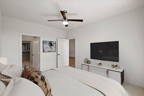 Overland Park apartment for rent - a bedroom with a bed and a ceiling fan