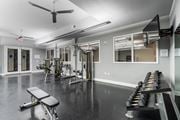 Kansas City apartment for rent - Free weights, strength machines, and mounted TV in fitness center at West 39th Street Apartments, Missouri, 64111