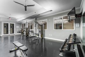 Kansas City apartment for rent - Free weights, strength machines, and mounted TV in fitness center at West 39th Street Apartments, Missouri, 64111