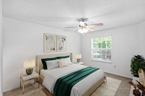 Overland Park apartment for rent - a bedroom with a bed and a ceiling fanat Stonebriar Apartments, Overland Park, Kansas