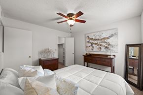 Overland Park apartment for rent - A bedroom with a large bed and a ceiling fan. at Coventry Oaks Apartments, Overland Park