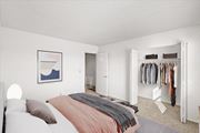 Overland Park townhouse for rent - a bedroom with a bed and a closet at Sheridan Ridge Townhomes Apartments, Overland Park