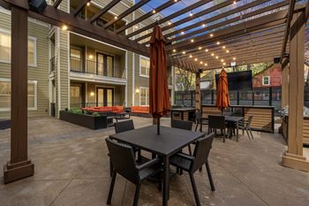 Outdoor lounge with pergola & tv at west 39th street apartments