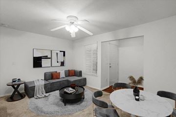 Olathe apartment for rent - a living room with a round table and a ceiling fan